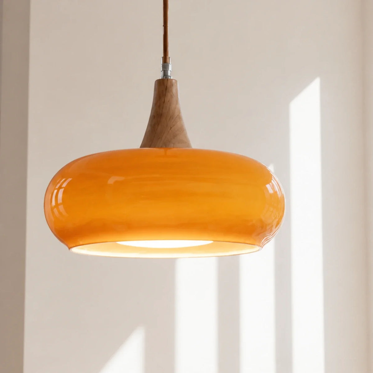 Orange Marie dome glass pendant in a bright sunlit interior