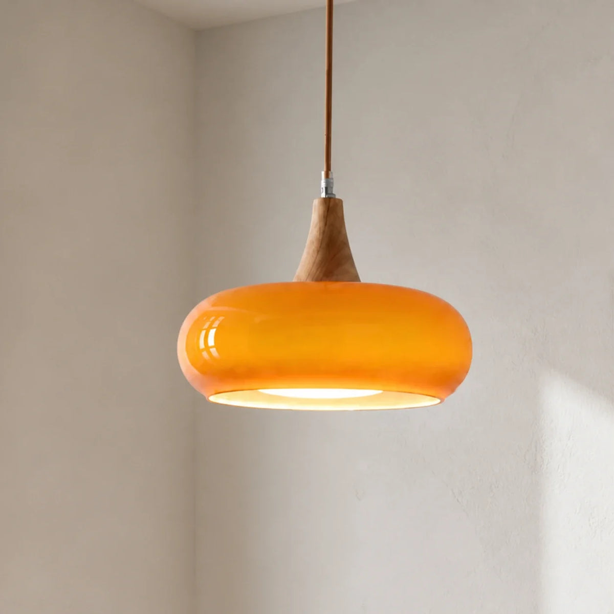 Orange Marie dome glass pendant close-up in a bright room