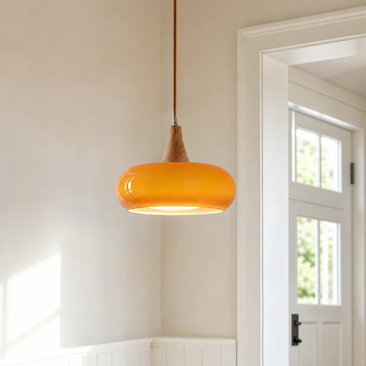 Orange Marie dome glass pendant in a sunlit entryway