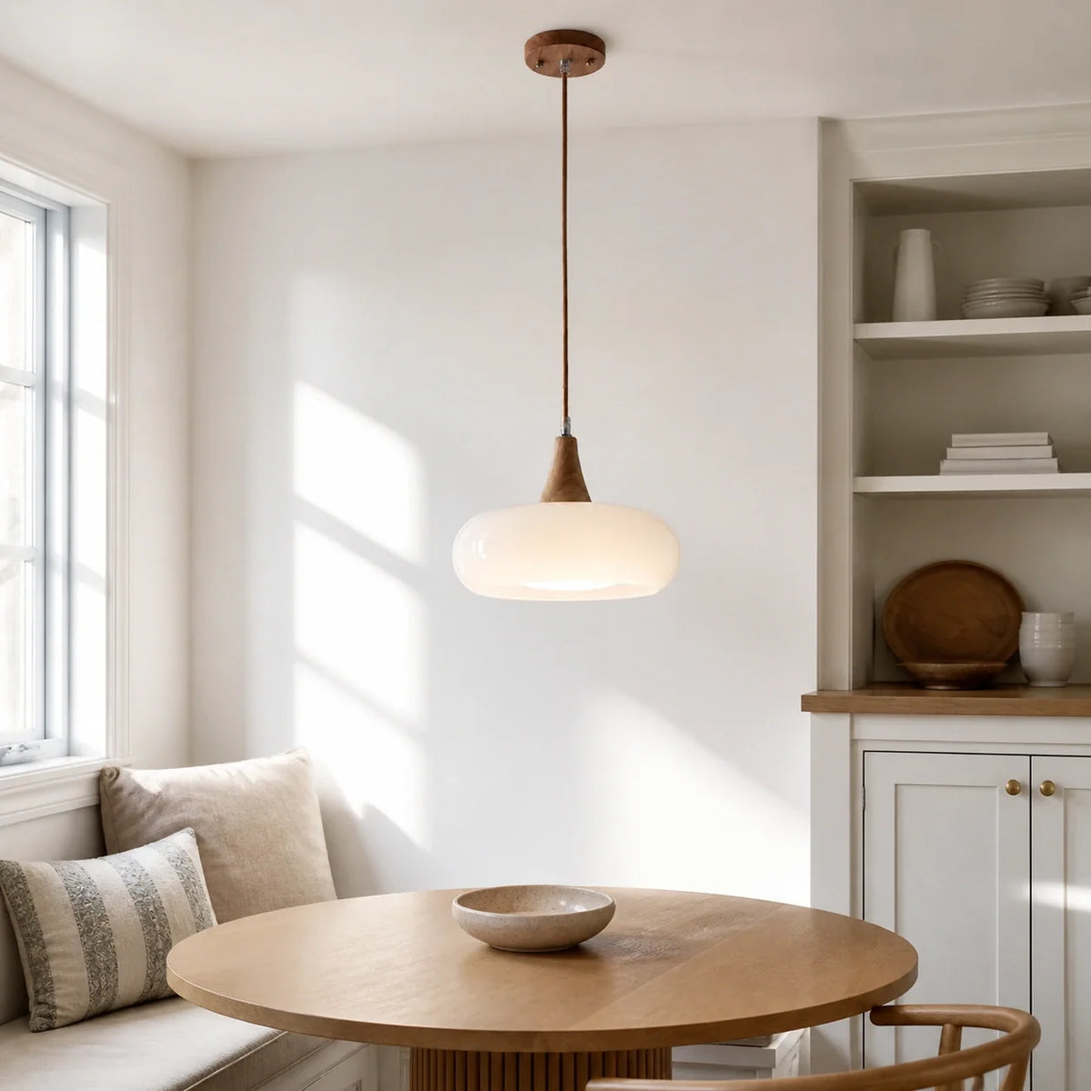 White Marie dome glass pendant above a round dining table
